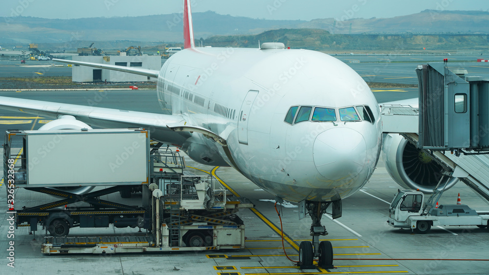 Beautiful new plane at the passenger airport. landing people in a white planes. Retractable gangway. gate, turbine wing, travel Beautiful new plane at the passenger airport. landing people in a white planes. Retractable gangway. gate, turbine wing, travel