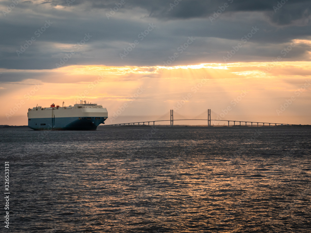Obraz premium Cargo Ship by Bridge