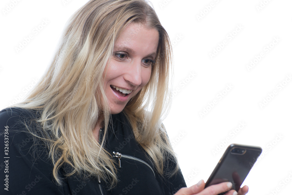 Portrait of a surprised, smiling woman using a smartphone Portrait of a surprised, smiling woman using a smartphone