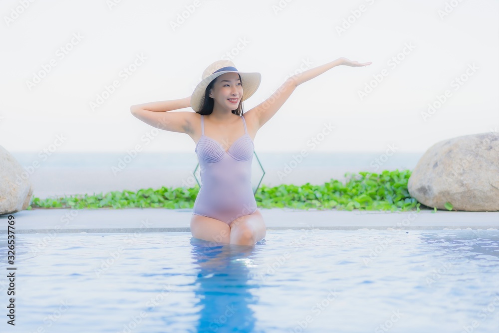 Portrait beautiful young asian woman happy smile relax around outdoor swimming pool in hotel resort Portrait beautiful young asian woman happy smile relax around outdoor swimming pool in hotel resort