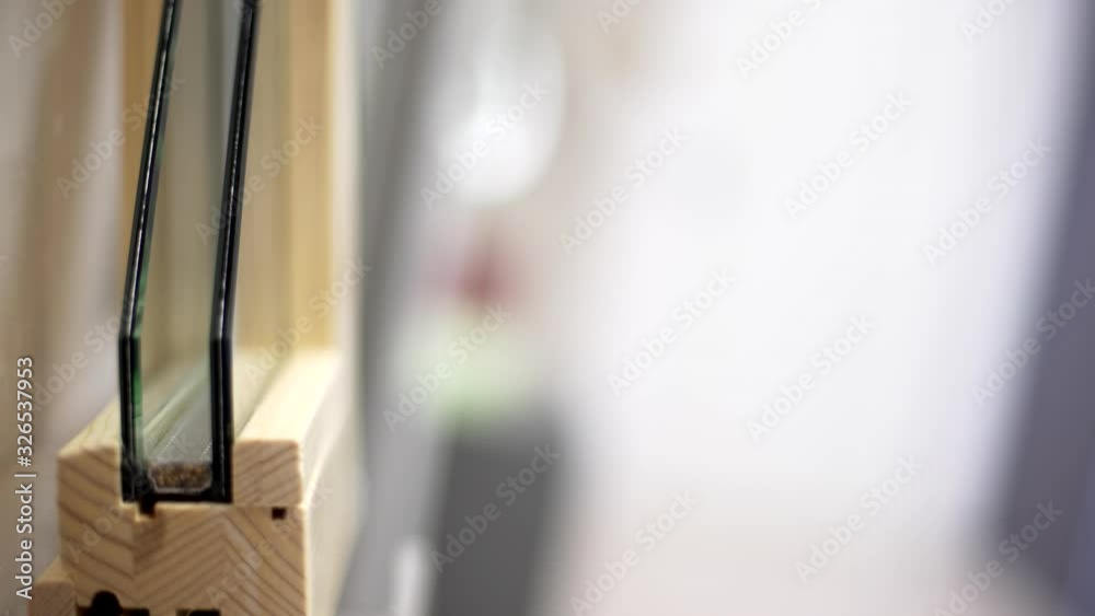 Dolly in shot of section of wooden window frames with double glazing in a siding factory or in a siding shop.