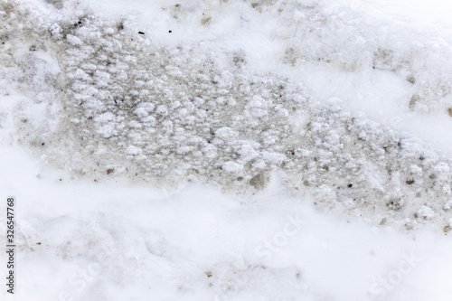 Dirty snow spring background. Spring time. Old and dirty snow texture. Natural background