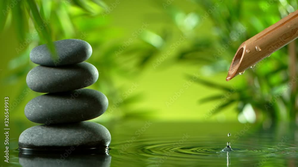 Super slow motion of leaking water stream from bamboo, spa and wellness concept. Filmed on very high speed cinema camera, 1000 fps.