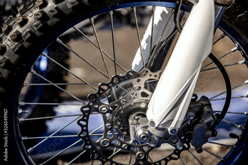 Close-up of the front wheel of a racing cross-country motorcycle. Lifestyle.