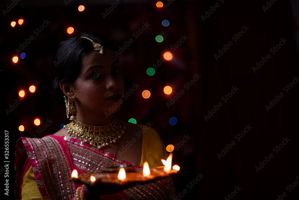 An young and beautiful Indian Bengali woman in Indian traditional dress