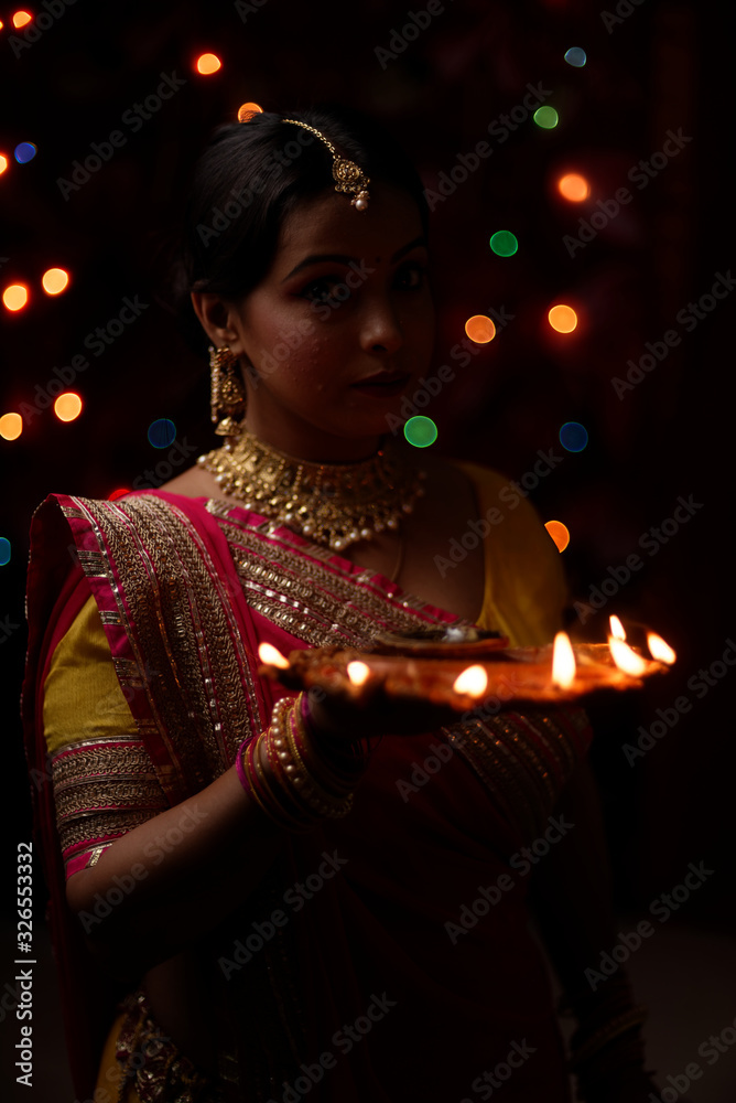 An young and beautiful Indian Bengali woman in Indian traditional dress