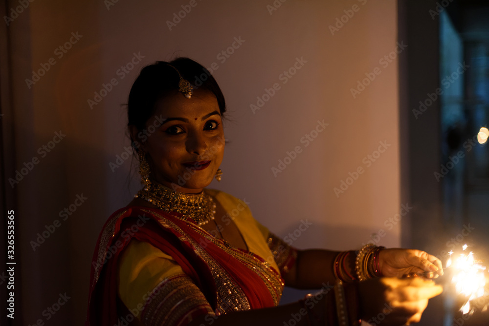 Young and beautiful Indian Bengali woman in Indian traditional dress is