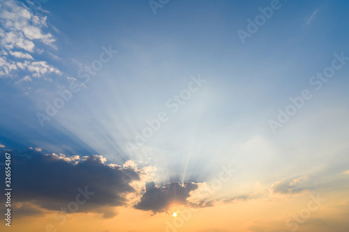 Sunset with clouds and crepuscular rays in evening, for background