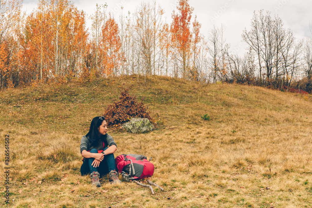 Woman is hiking in colorful nature scenic of forest and hills. Woman is hiking in colorful nature scenic of forest and hills.