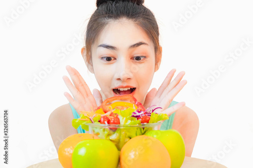 Young beautiful asian woman wore yellow undershirt, Holding a salad glass cup isolated on white background dummbell photo