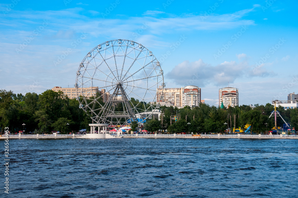 Russia, Khabarovsk, August 2019: Ferris Wheel on the Bank of the Amur river in the city of Khabarovsk in the summer