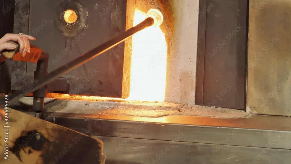 Artist pulling molten glass from furnace. Static, slomo Artist pulling molten glass from furnace. Static, slomo