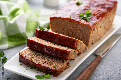 Meatloaf with spicy glaze sliced on a plate, ground beef and pork dish