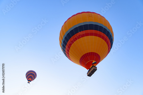 Flying hot air balloons in the sky in Goreme, Cappadocia, Turkey