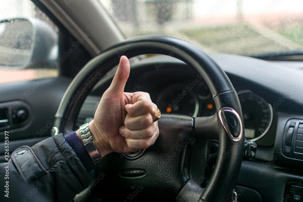 Man's hands on a steering wheel Man's hands on a steering wheel
