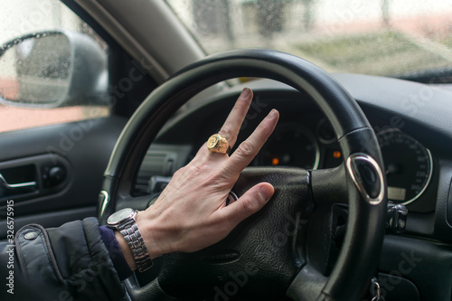 Man's hands on a steering wheel © kott73