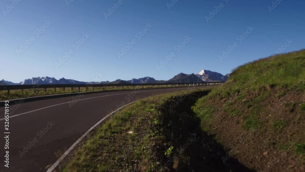 Empty serpentine road with fence, Kislovodsk - Dzhily Su asphalt dangerous beautiful winding freeway to Mount Elbrus in caucasus mountains at summer sunny morning - Aerial drone view Empty serpentine road with fence, Kislovodsk - Dzhily Su asphalt dangerous beautiful winding freeway to Mount Elbrus in caucasus mountains at summer sunny morning - Aerial drone view