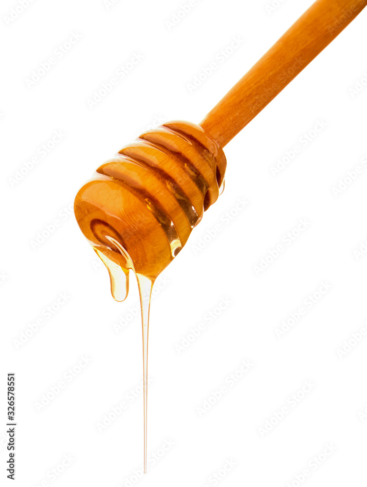 Honey drops drain down the wooden dipper isolated on white background Honey drops drain down the wooden dipper isolated on white background