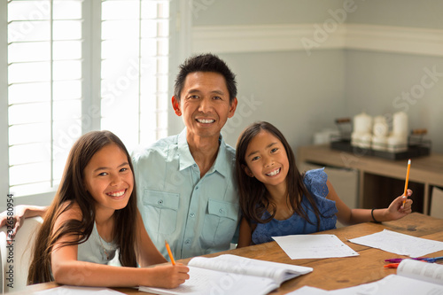 Mother Helping Her Daughters With Their Homework photo