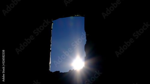  The sun in the window of a destroyed house