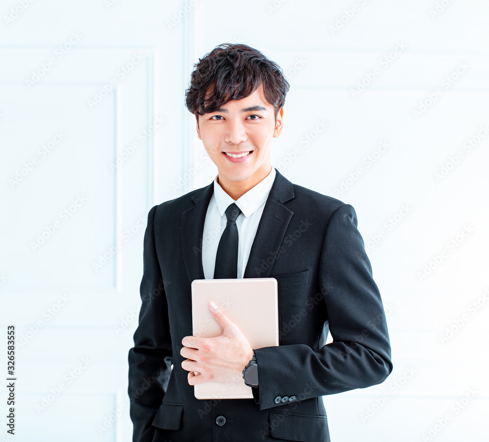 young Businessman using tablet computer in office young Businessman using tablet computer in office
