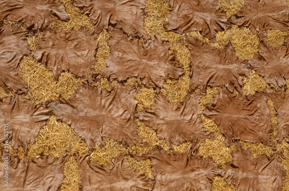 Abstract of processed tanned hides drying on straw in the sun in el Bali Medina Fes Morocco