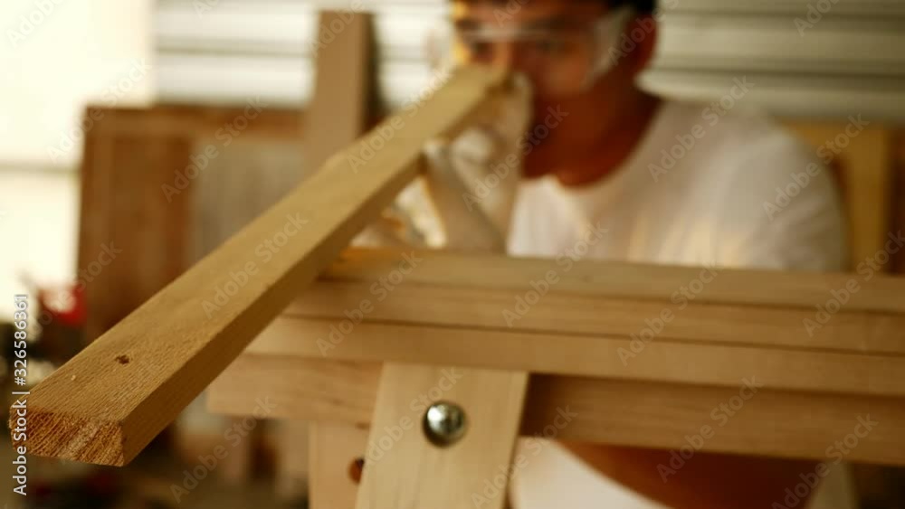 Woodwork and furniture making concept. Stylish craftsman working in his carpentry workshop Woodwork and furniture making concept. Stylish craftsman working in his carpentry workshop