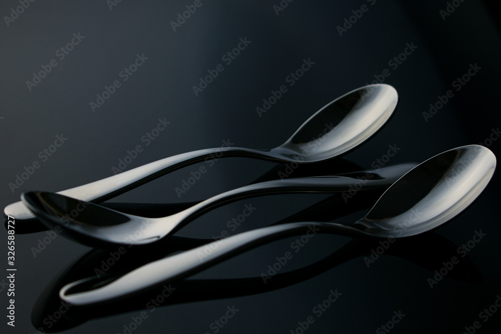teaspoons on a glass table.silver plate. teaspoons on a glass table.silver plate.