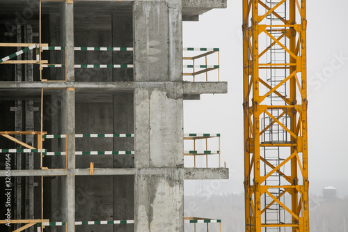 construction of a multi-storey residential building at winter time.