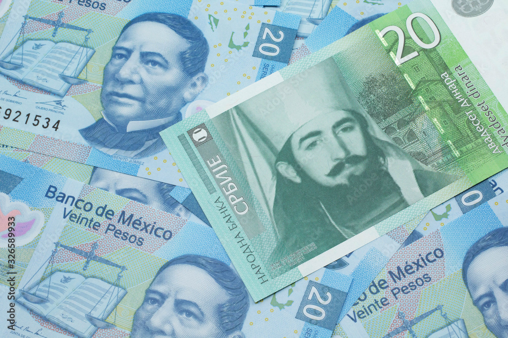 Fototapeta premium A close up of a green and white, twenty Serbian dinar bank note on a background of Mexican twenty peso bank notes