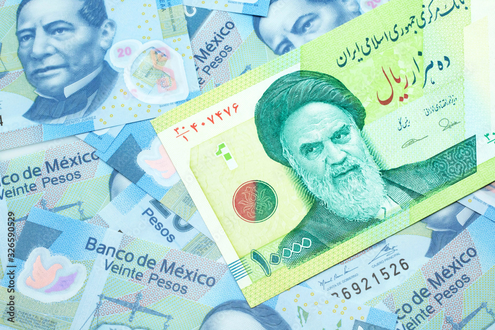 Fototapeta premium A macro image of a green ten thousand rial bank note from Iran on a bed of Mexican twenty peso bank notes close up