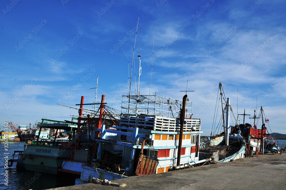 Fototapeta premium View of Thai fishing port on a clear bright day. 