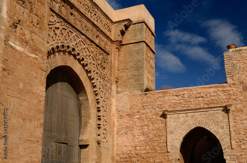 Red ochre stone arch of Bab Oudaia entrance gate to Kasbah in Rabat Morocco photo