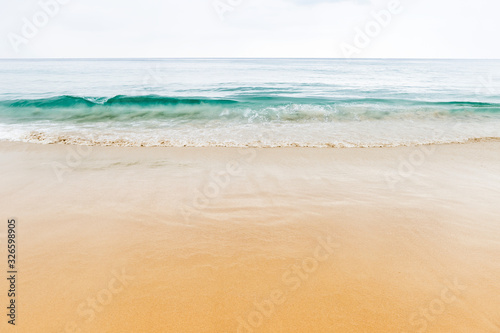 Beautiful smooth sand beach and green sea water, relaxing by the beach, outdoor cloudy day light