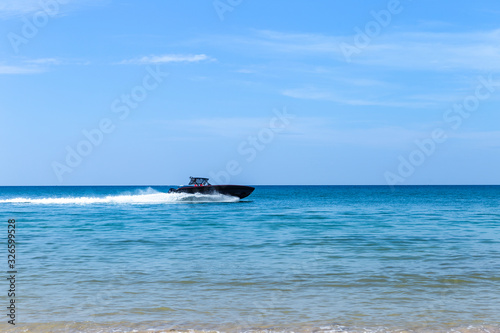 Fototapeta Naklejka Na Ścianę i Meble -  Speed boat on blue sea over clear blue sky, summer outdoor day light, fast transportation