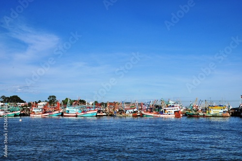 View of Thai fishing port on a clear bright day. 