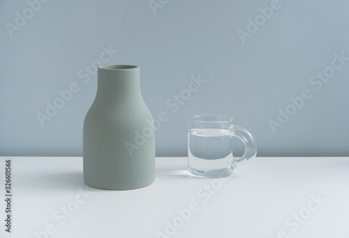 A vase and a clear glass in a minimalist home photo