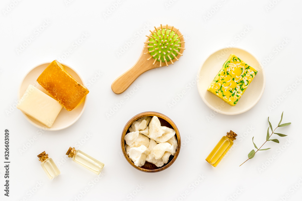 Coconut, argan and jojoba oil for hair. Set with brush on white background top-down Coconut, argan and jojoba oil for hair. Set with brush on white background top-down