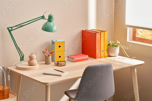 Table with colorful stationery in home office