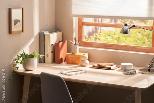 Table with stationery in corner near window