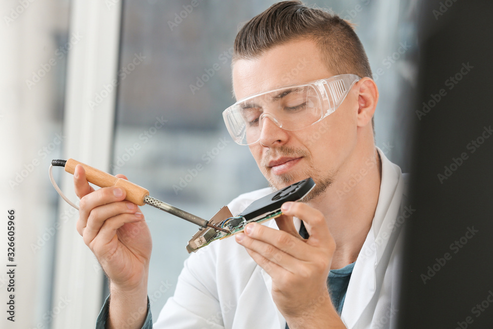 Electronic technician working in service center Electronic technician working in service center