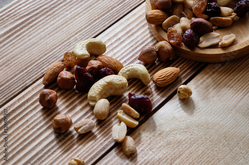 Mix of nuts and dried fruits at weathered wooden background