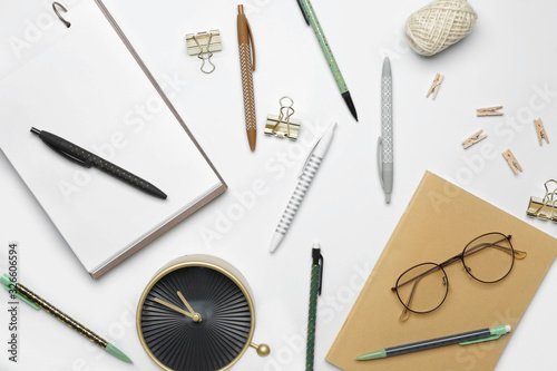 Set of school supplies with clock on white background