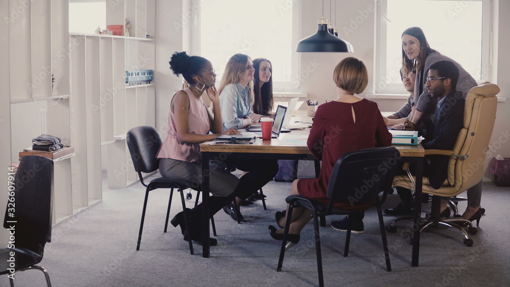 Happy female boss leading office meeting. Multiethnic employees listening to manager instructions in modern coworking 4K Happy female boss leading office meeting. Multiethnic employees listening to manager instructions in modern coworking 4K