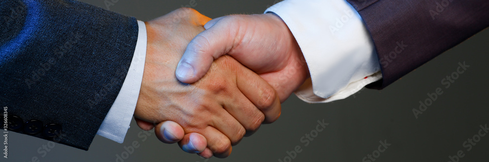 Man in suit shake hand as hello in office closeup. Friend welcome, mediation offer, positive introduction, greet or thanks gesture, summit participate approval, motivation, strike arm bargain concept Man in suit shake hand as hello in office closeup. Friend welcome, mediation offer, positive introduction, greet or thanks gesture, summit participate approval, motivation, strike arm bargain concept