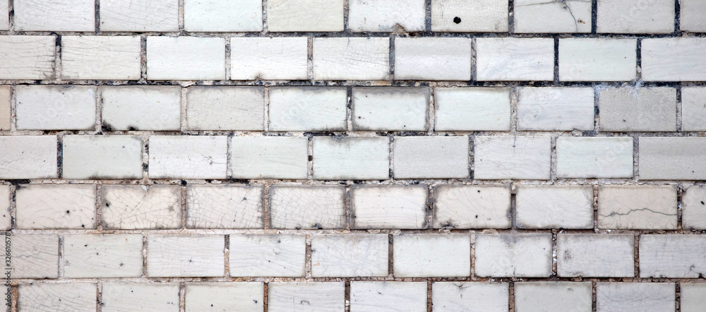 Obraz premium Old small tiles square shape on a wall