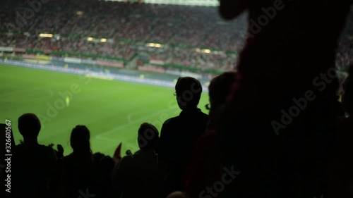 silhouettes of many soccer fans in football stadium watching match clapping hands to support teams, with audio