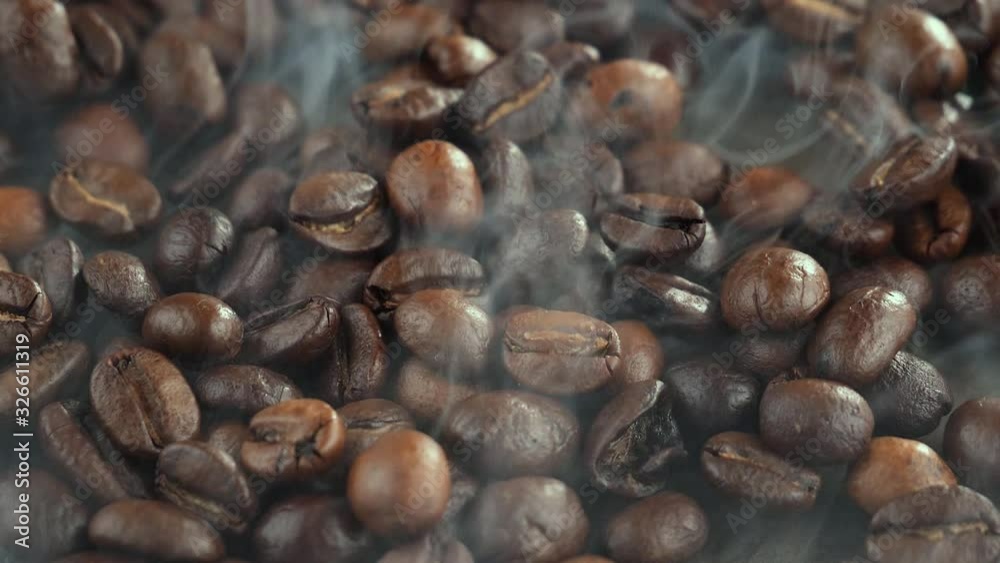 The coffee beans are roasted and mixed with a spoon. The coffee beans are roasted and mixed with a spoon.