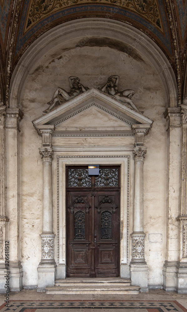 Door of a historical building in the old town of Vienna, Austria, Central Europe. Sculptures, figures, ornaments, architectural background.