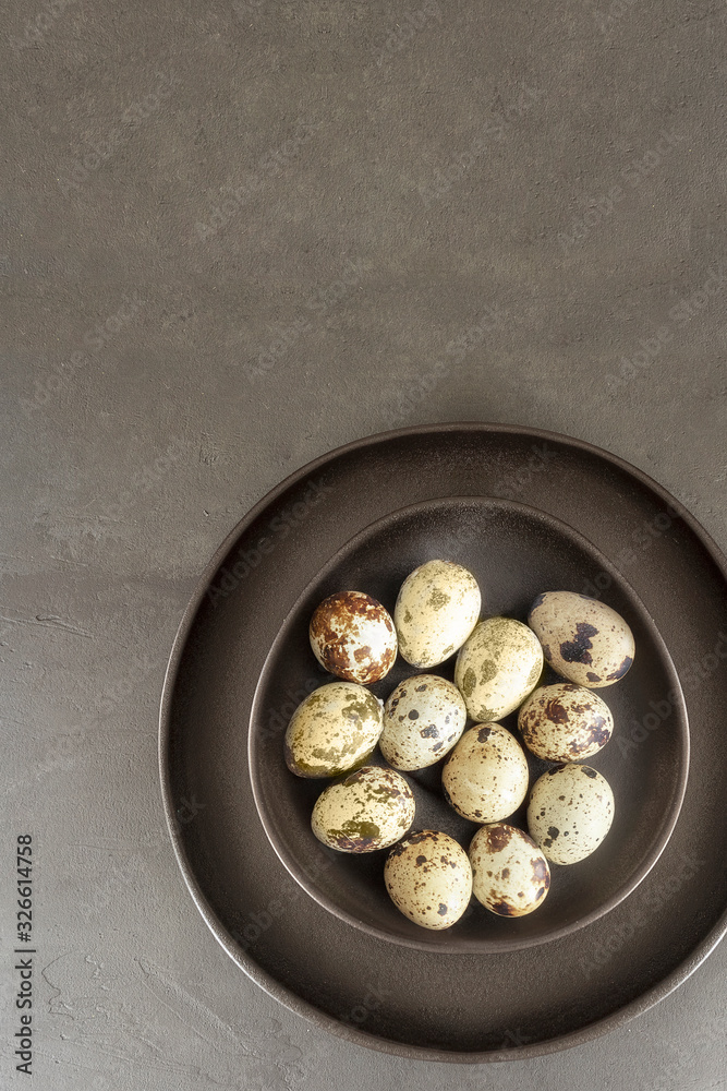 Black Egg Shaped Plate with quail eggs on dark concrete background.Happy Easter concept.Copy space Black Egg Shaped Plate with quail eggs on dark concrete background.Happy Easter concept.Copy space